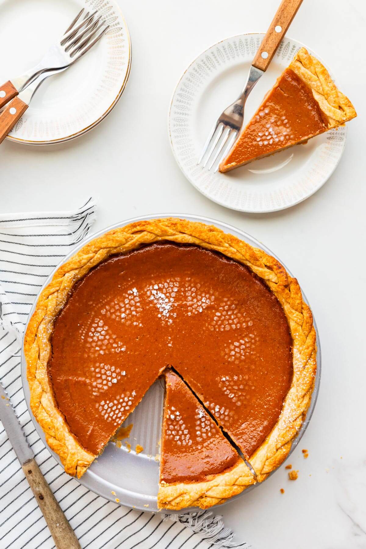 Slicing and serving apple butter pie on small dessert plates.