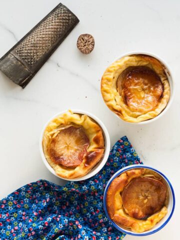 Apple clafoutis sweetened with maple & a little nutmeg - it's like a baked custard with apples. Totally comforting and perfect dessert for apple season and fall.Apple clafoutis sweetened with maple & a little nutmeg - it's like a baked custard with apples. Totally comforting and perfect dessert for apple season and fall.