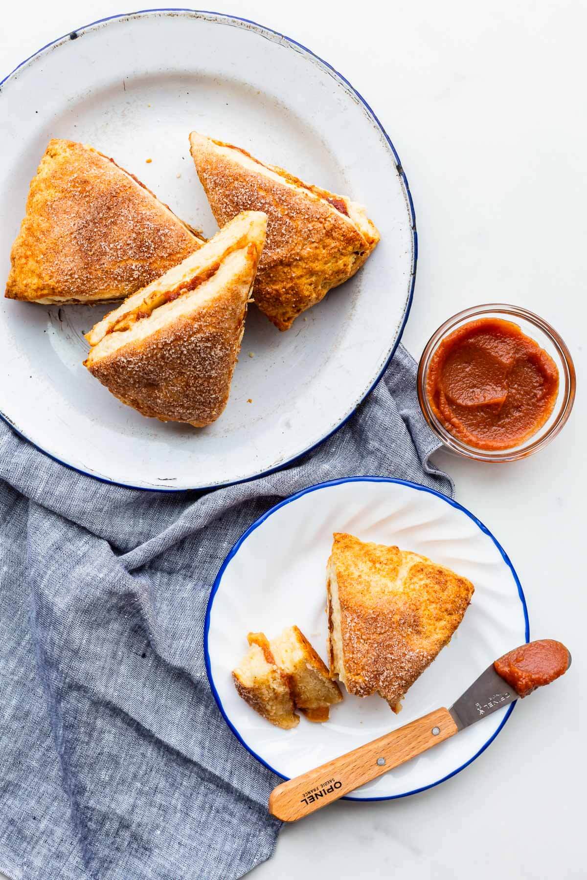 Serving apple pie scones on plates with apple butter.