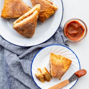 Serving apple cinnamon scones on small plates with apple butter.