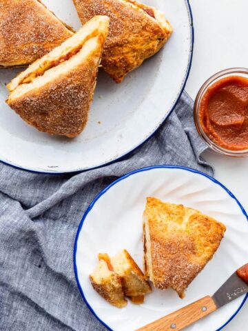 Serving apple cinnamon scones on small plates with apple butter.
