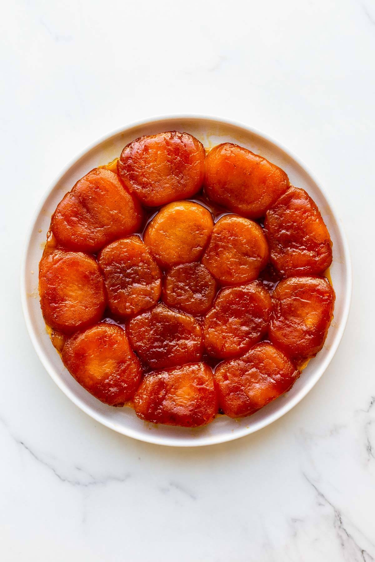 Apple tarte tatin on a white plate.
