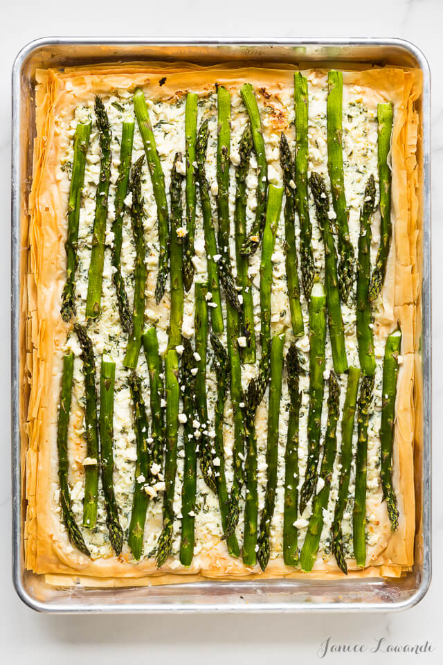 Asparagus phyllo tart with ricotta, feta, herbs, and lemon zest, baked