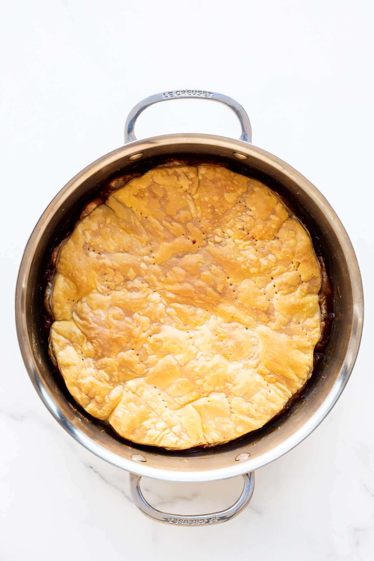 Apple tarte tatin baked and ready to be flipped on a plate to serve