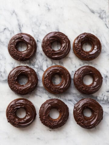 Baked chocolate donuts glazed with chocolate ganache