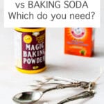 A box of baking soda and a container of Magic baking powder with a set of measuring spoons for scooping these chemical leaveners