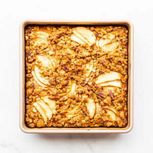 An apple cake baked in a square baking pan.