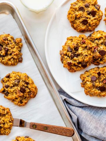 Transferring baked banana oatmeal cookies to a plate to serve them.