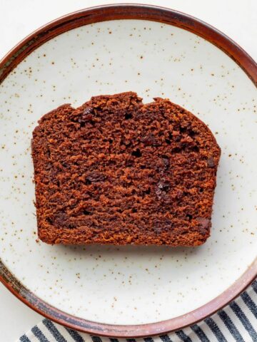A slice of double chocolate banana bread on a plate.