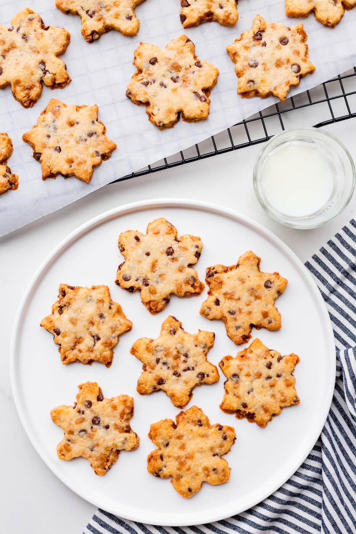 Shortbread cookies with coconut, chocolate chips, and toffee bits cut out into snowflakes.