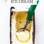 Cardamom ice cream in a loaf pan being scooped with a disher