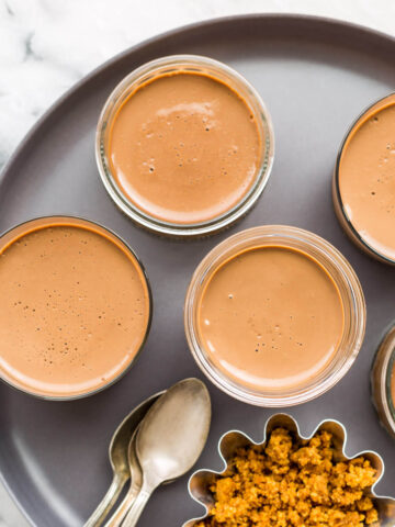 Jars of milk chocolate pots de crème, ready to be enjoyed.