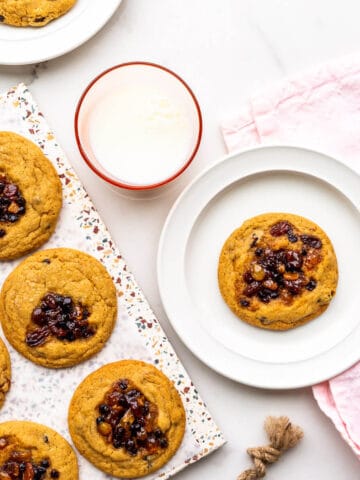 Freshly baked mincemeat cookies served with a glass of milk.