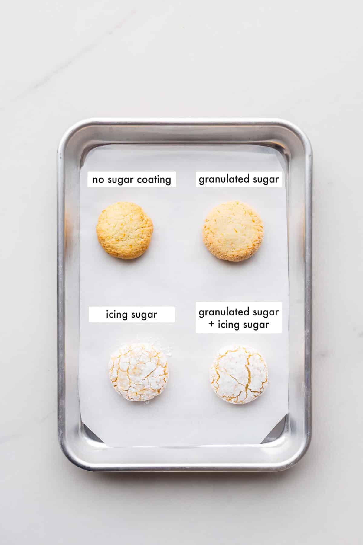 Comparing rolling scoops of amaretti cookie dough in granulated sugar, icing sugar, granulated and icing sugar, or without any coating to show that coating in both granulated and icing sugar creates the prettiest amaretti cookies.