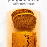 Sliced eggless pumpkin bread on wood cutting board