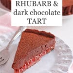 Slice of rhubarb chocolate tart on a light blue ceramic plate with a fork, pink napkin