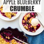 An apple and blueberry crumble being served with vanilla ice cream.