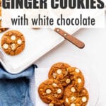 Transferring freshly baked ginger white chocolate cookies from the sheet pan to a plate.
