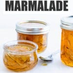 Jars of homemade lime marmalade on a cooling rack made with an easy lime marmalade recipe.