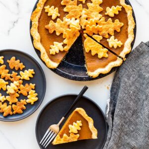 Serving pumpkin pie on black plates.