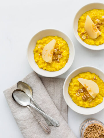 Golden milk rice pudding spiced with turmeric, ginger, cardamom, and cinnamon served with poached pears