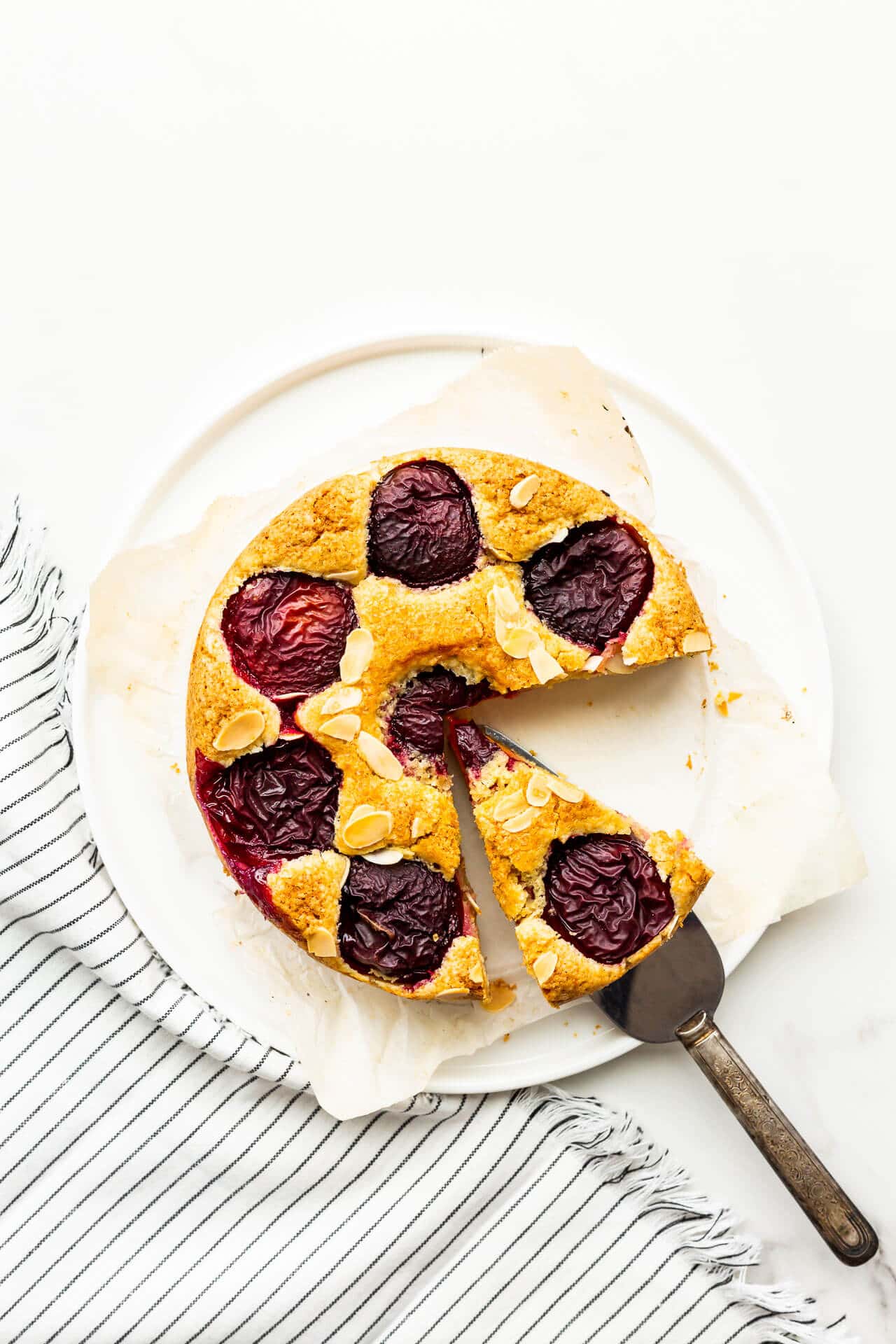 Slicing and serving a plain plum cake