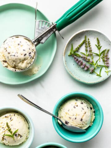 Green bowls with scoops of homemade mint chocolate chip ice cream.