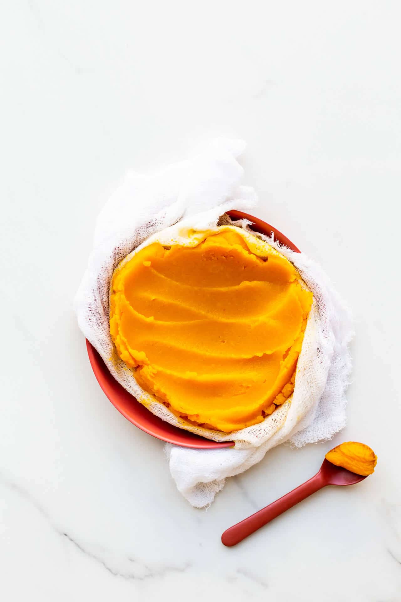 Homemade pumpkin purée strained through a cheesecloth.