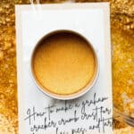 A baked graham cracker crumb crust in a springform pan.