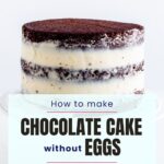 A chocolate layer cake with cream cheese frosting on a cake stand.