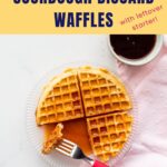 Homemade waffle served with maple syrup.