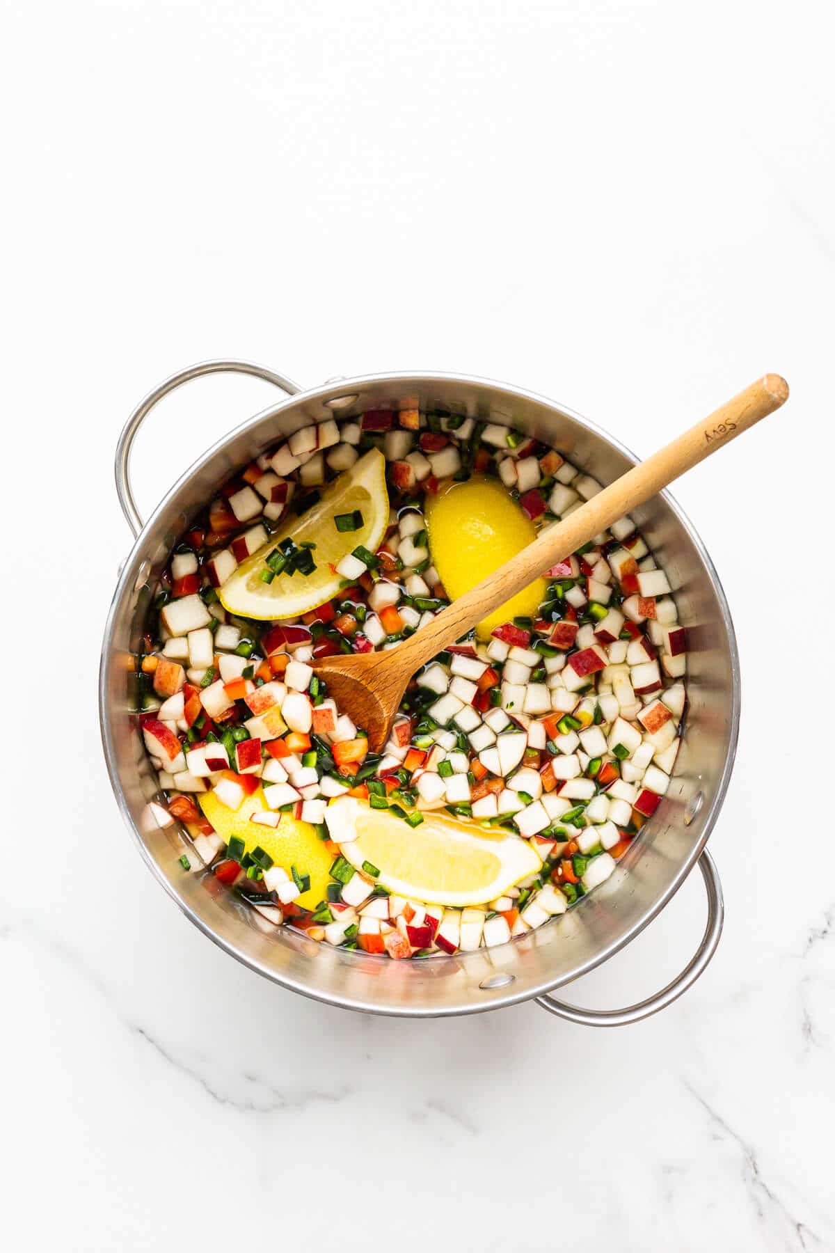 Ingredients for jalapeño jam combined in a big pot and ready to be cooked down on the stove.
