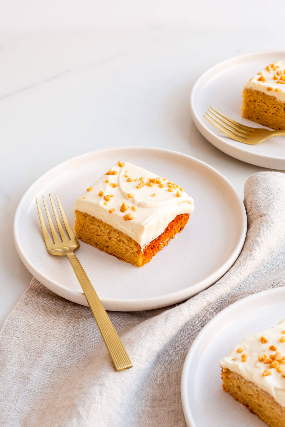 Squares of maple cake on dessert plates.