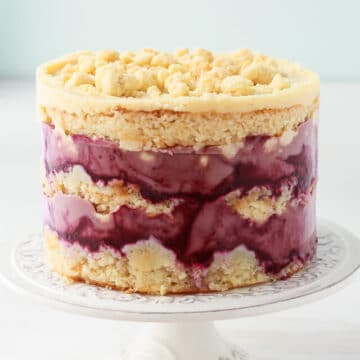 Milk crumbs on a Momofuku Milk Bar style cake-layers of blackberry curd, almond cake, and almond frosting