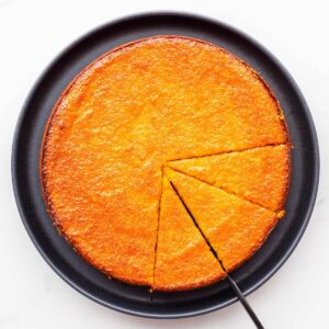 Slicing and serving a glazed orange cake