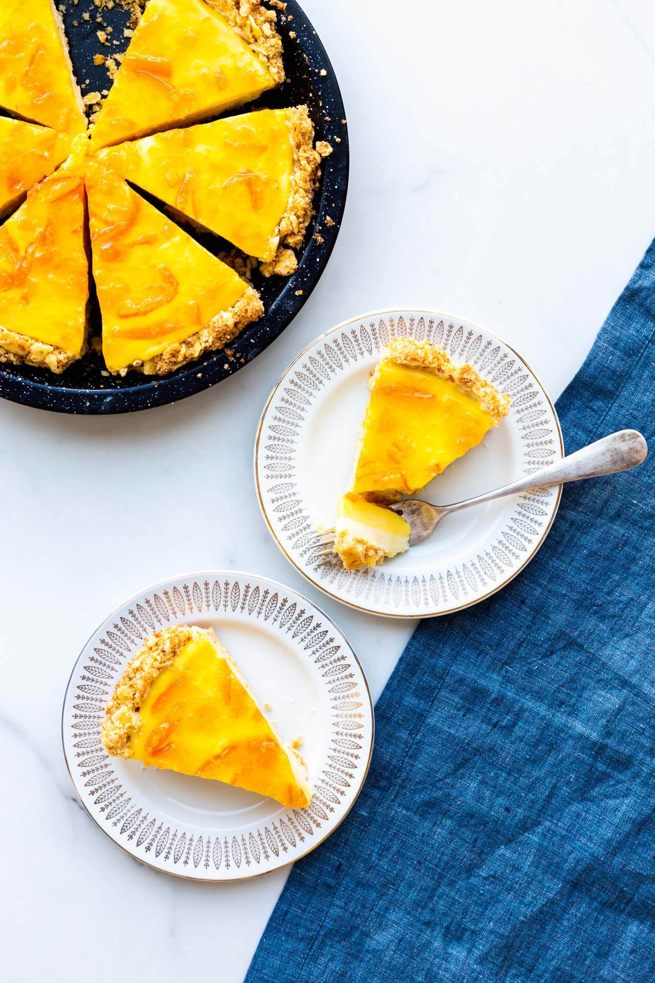 Orange curd pie sliced and served on small dessert plates.