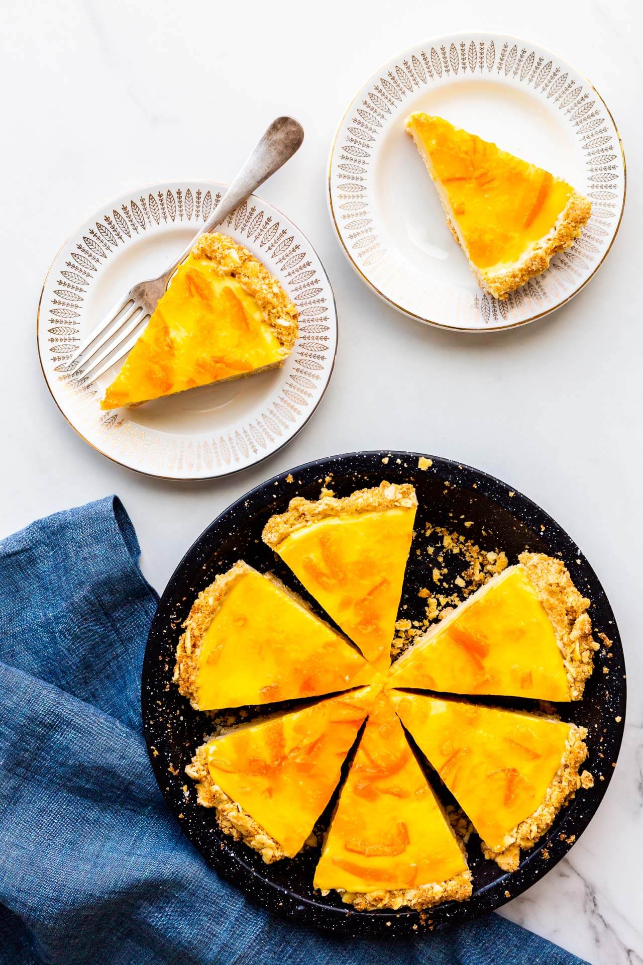 Orange pie with saltine crust sliced and served on small dessert plates.