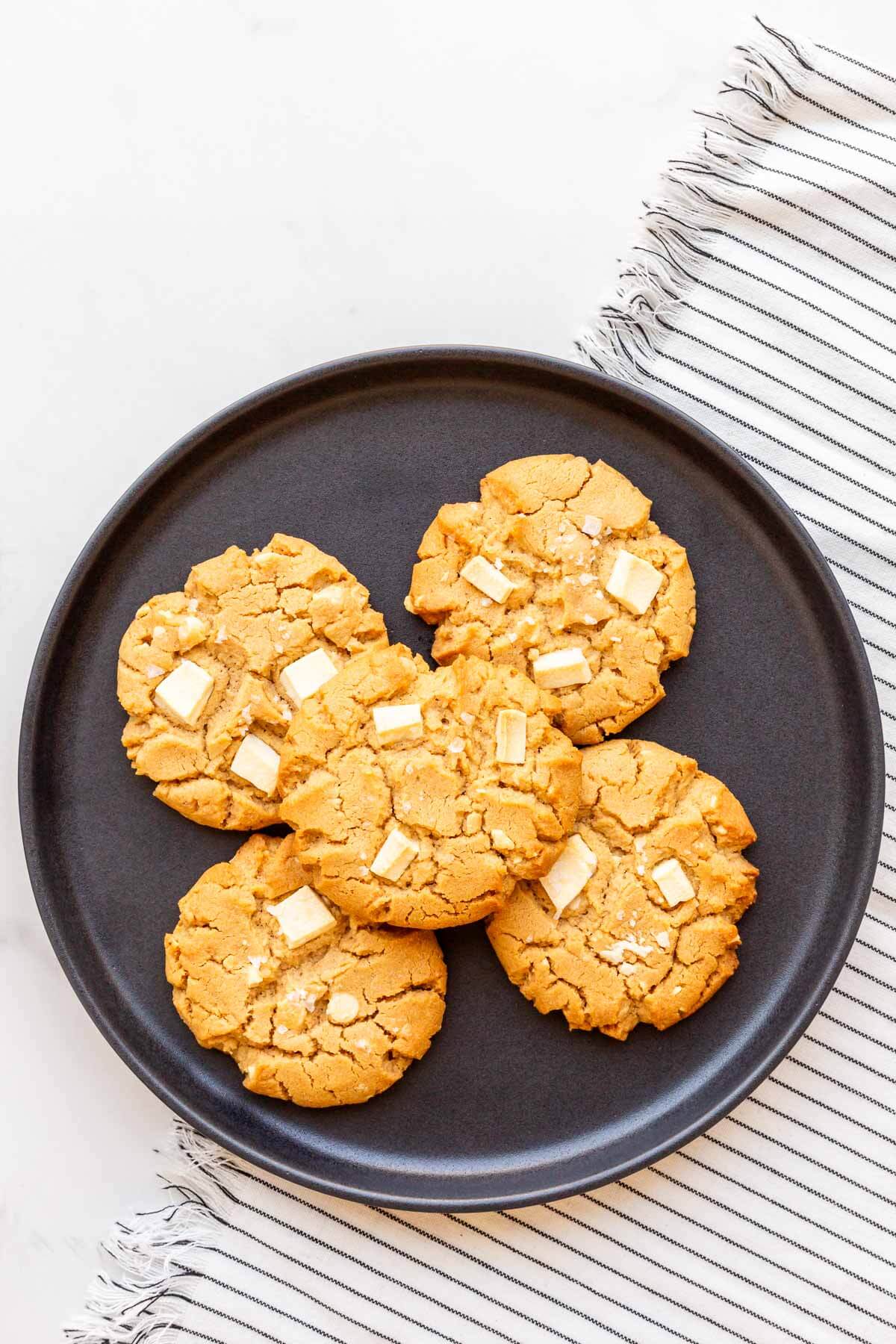 A black plate of peanut butter cookies.
