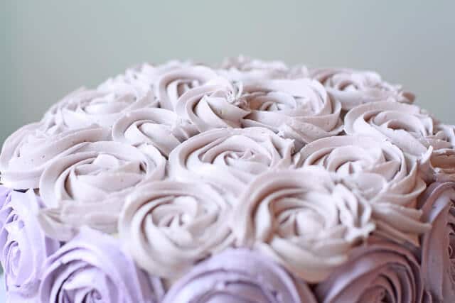 Italian meringue buttercream coloured pale lilac and piped on top of a cake to make a buttercream rose cake
