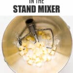 Cubes of cold butter over dry ingredients in stand mixer bowl with paddle attachment to make pie crust.