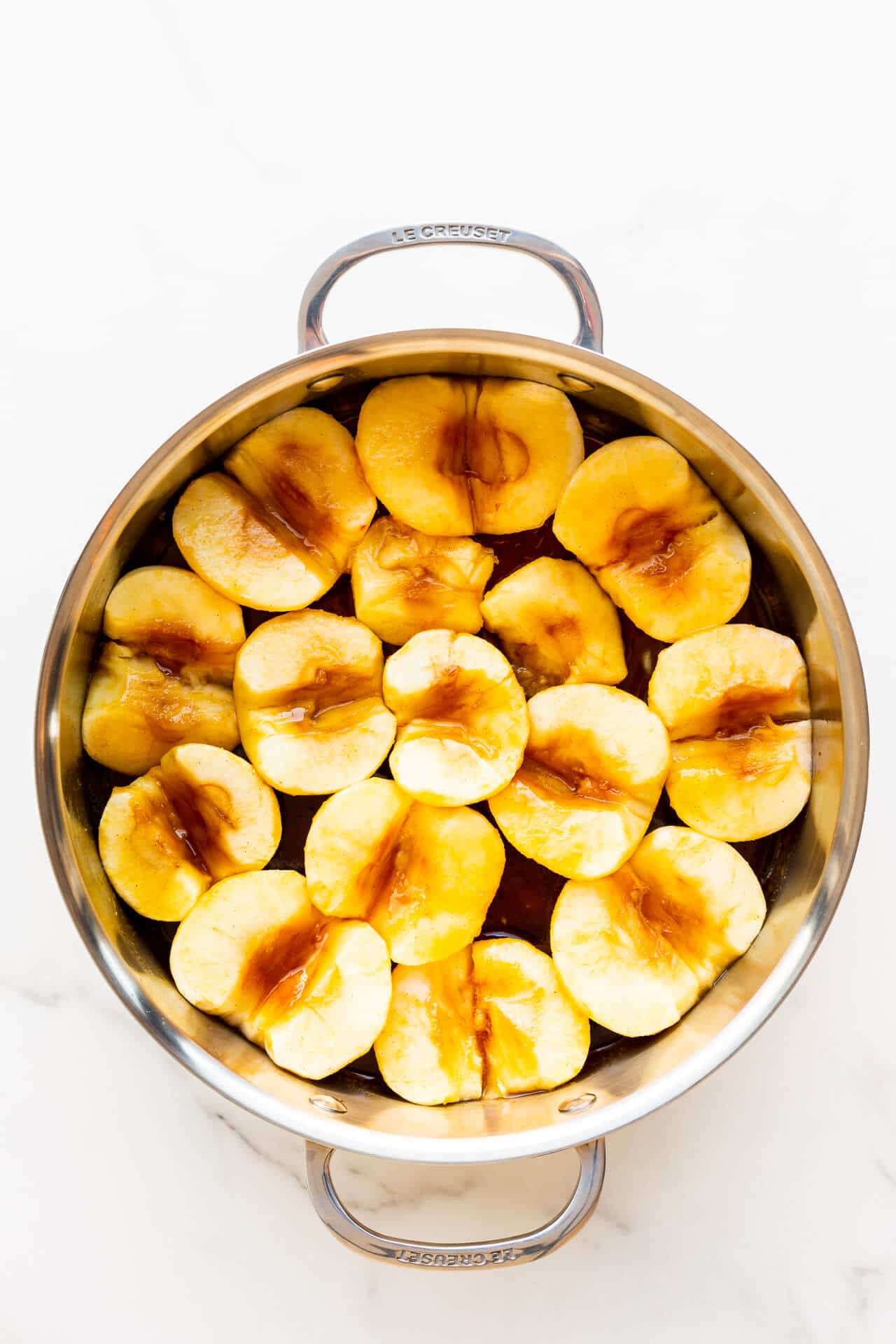 Apples arranged in a pan of caramel ready to be baked for apple tarte tatin.