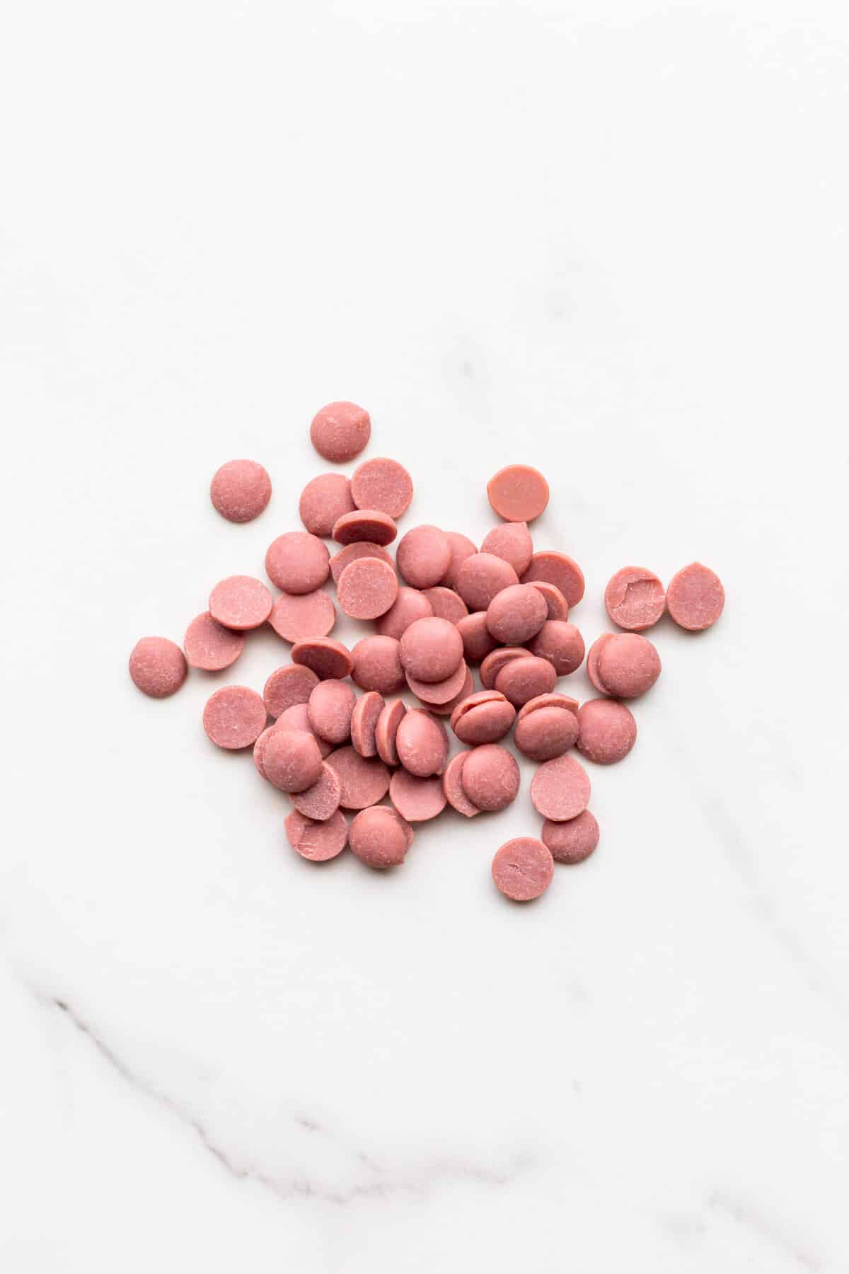A pile of pink ruby chocolate buttons from Cacao Barry.