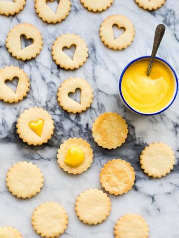 Sandwiching coconut cookies with grapefruit curd