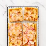 Puff pastry apple tart cut into squares to serve.