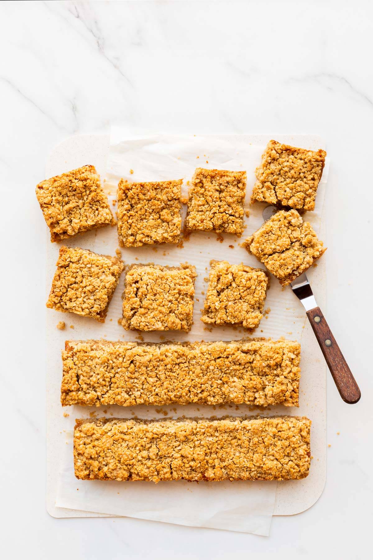 Slicing applesauce oatmeal bars into squares to serve them.