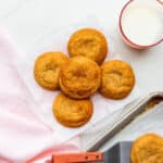 A plate of freshly-baked homemade snickerdoodles transferred from the cookie sheet with a spatula.
