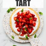 Serving a strawberries and cream tart on a terrazzo board.