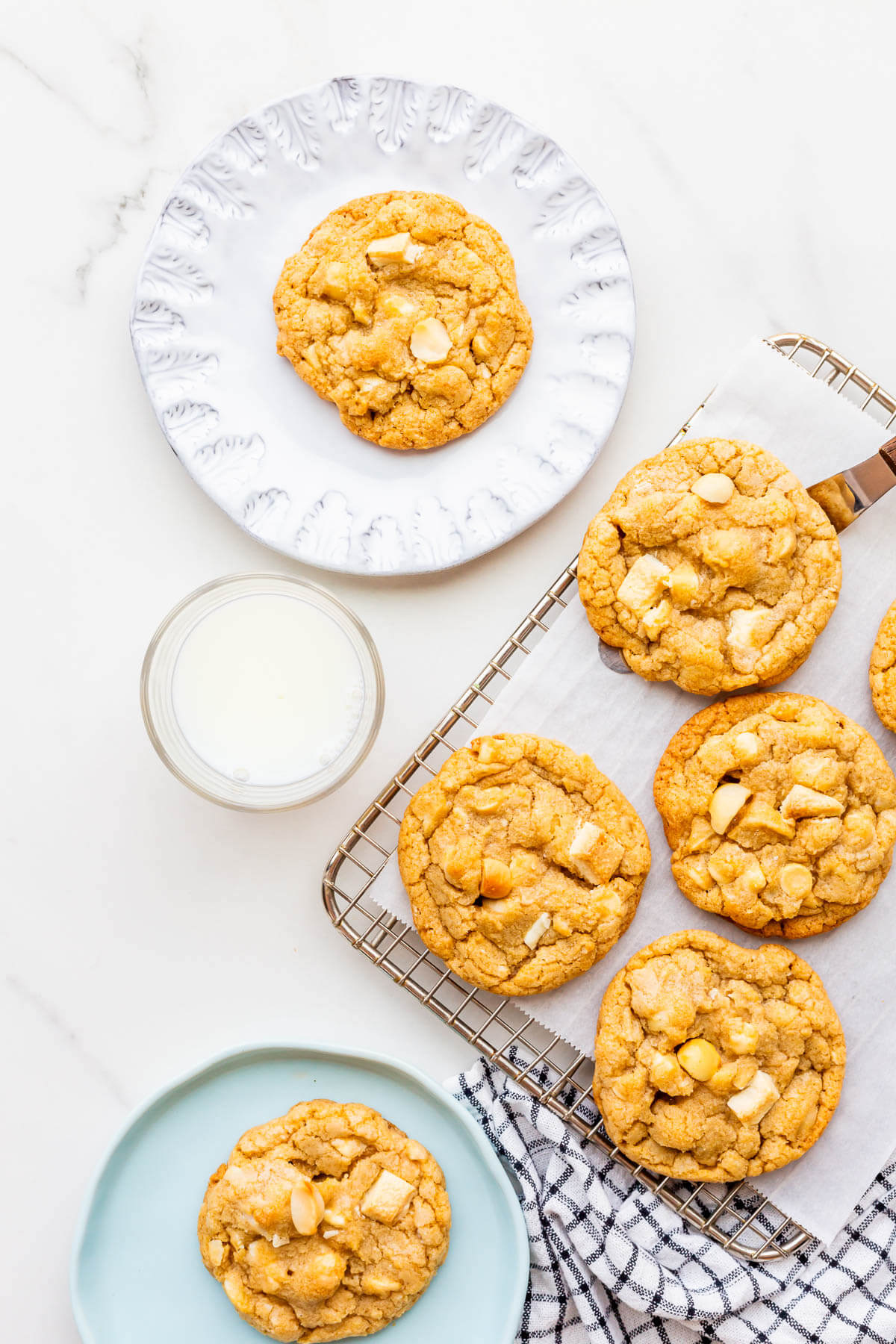 Serving white chocolate macadamia nut cookies with a glass of milk.