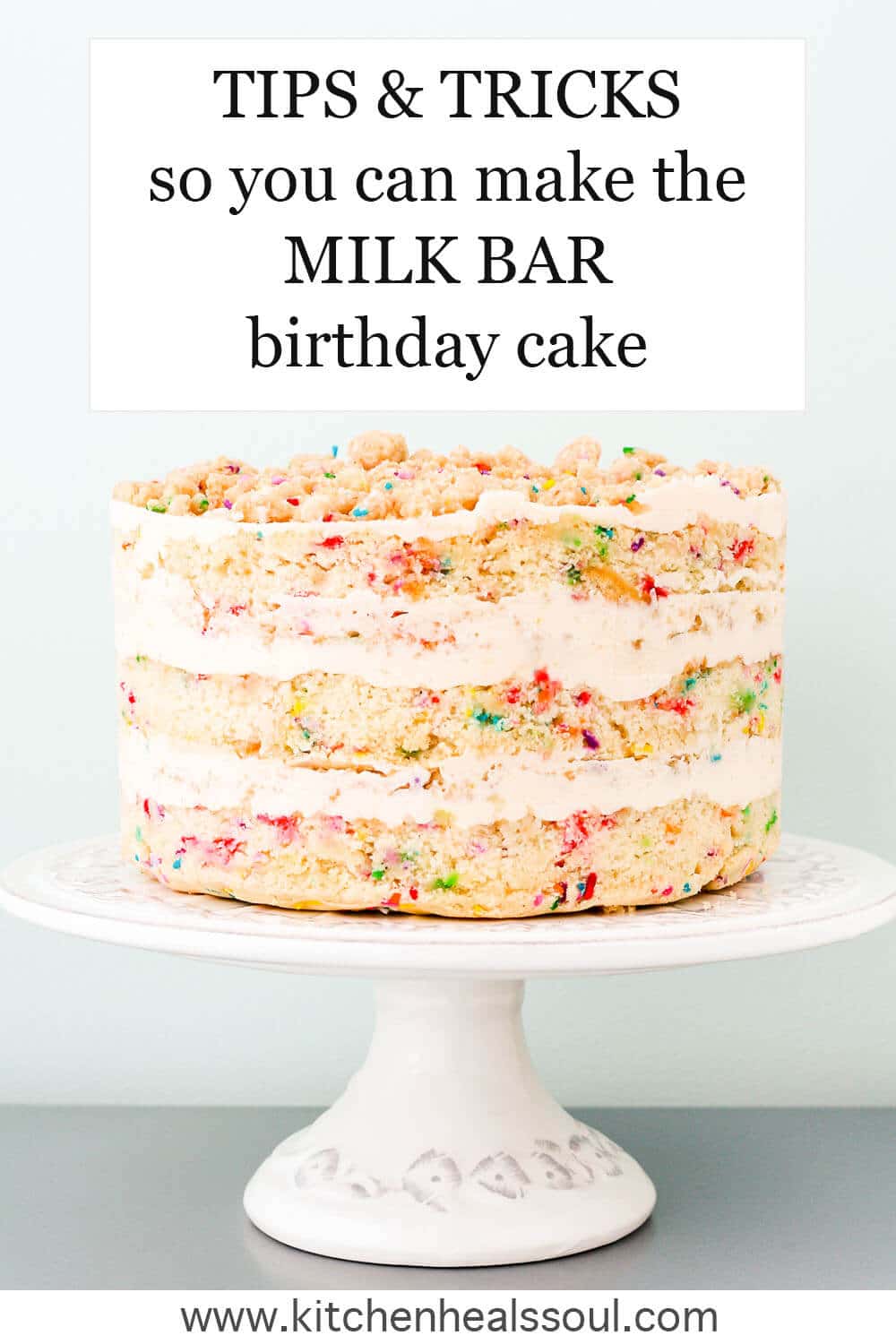 Milk Bar-style "naked" sprinkle birthday cake on a cake stand