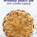 Whiskey peach pie with crumb topping and a crimped edge
